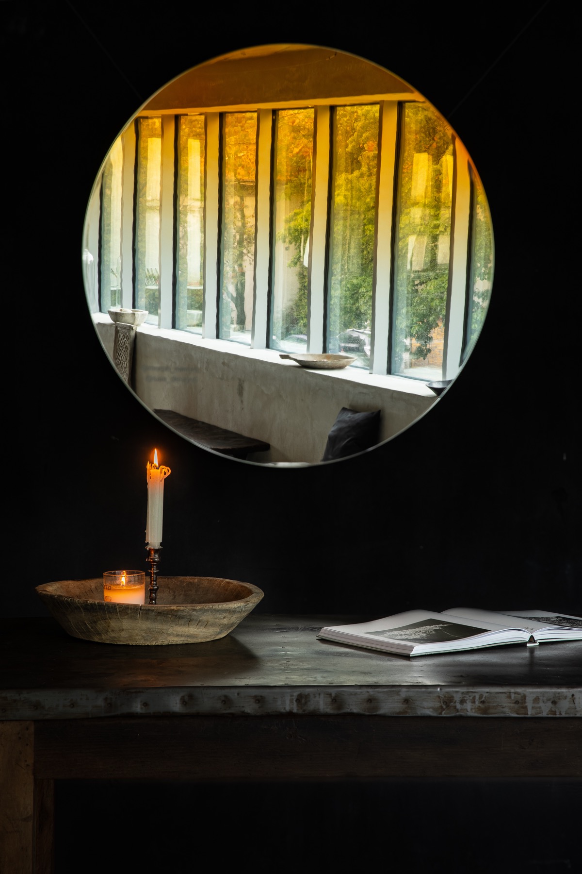 The Neptune mirror with a golden gradient catching the light of a window