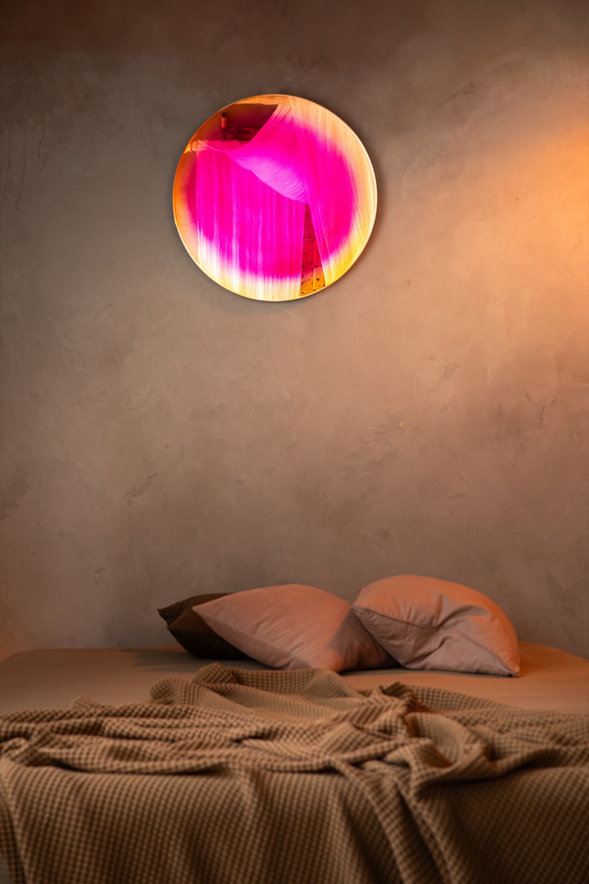 Detail of the Saturn mirror, the lacquered ring shifting between golden-green, pink and amber